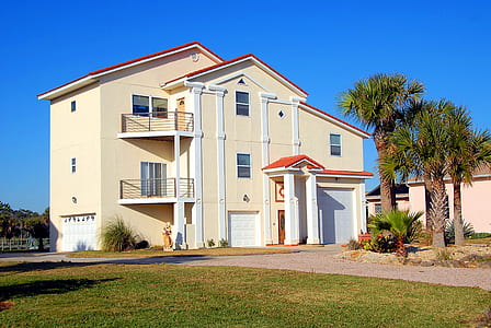 beige concrete house beside tree thumbnail