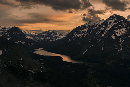 dark clouds over alp mountain near body of water thumbnail