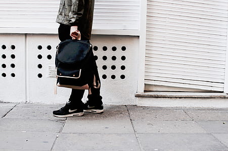 person holding backpack thumbnail