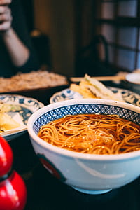 noodles on white ceramic bowl on black tray thumbnail