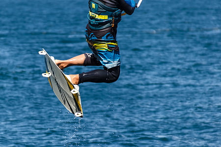 person riding wakeboard on body of water thumbnail