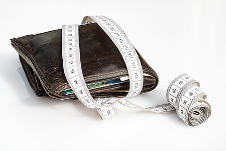 brown wallet covered with tape measur thumbnail