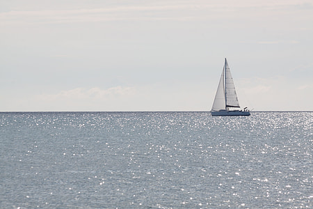 landscape photography of sail boat in middle ocean during day time thumbnail