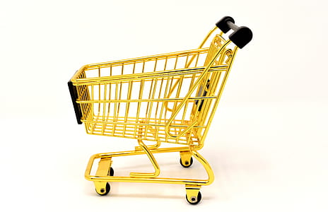 gold shopping cart placed on white floor thumbnail