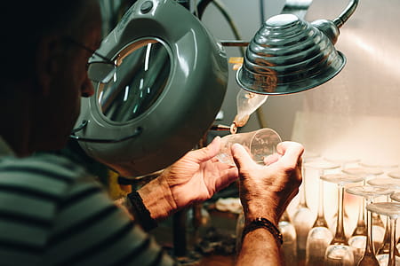 Man in White and Black Stripes Top While Making Drinking Glasses Using Grey Machine thumbnail
