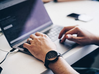 shallow focus photography of man typing on laptop thumbnail