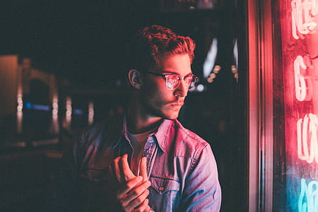 man looking at the neon signage thumbnail