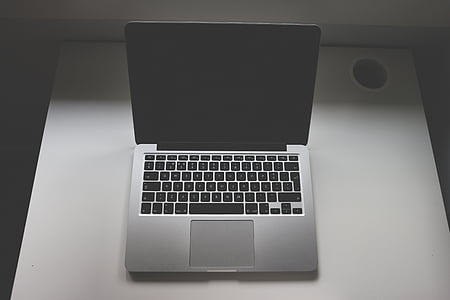 turned-off MacBook Pro on white table thumbnail