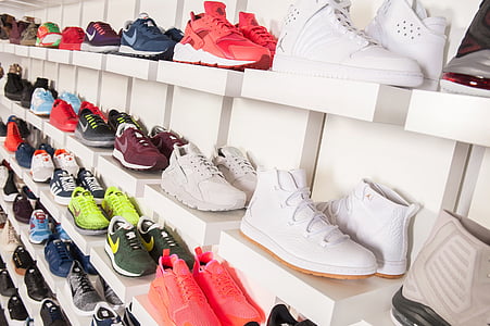 pair of assorted-color sneakers on shelf thumbnail