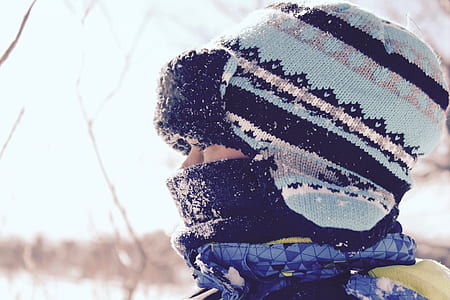 closeup photo of person wearing teal and black knit hat thumbnail