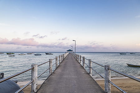 gray concrete dock beside sea thumbnail