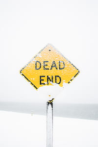 snow-covered yellow and black Dead End street sign thumbnail