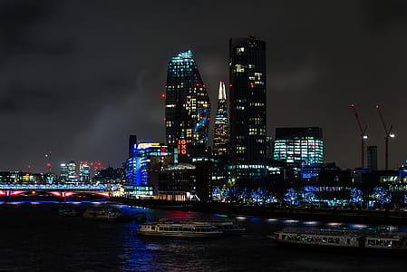 boat docked near buildings at night thumbnail