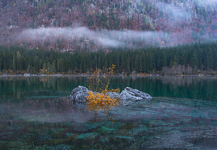 body of water surrounded by mountains thumbnail