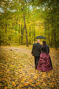 woman and man under umbrella walking thumbnail