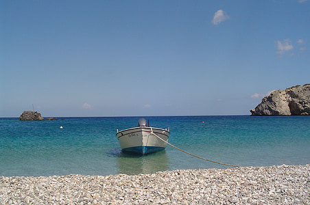 landscape photography of white boat in seashore thumbnail