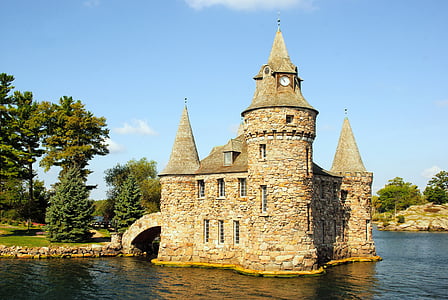 brown and white castle beside body of water thumbnail