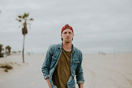 man standing on white sand and doing pose thumbnail