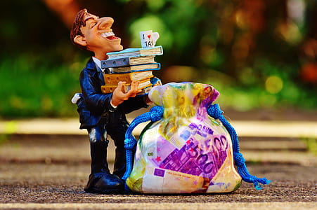 man carrying books figurine thumbnail