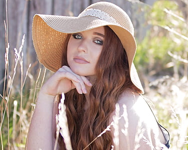 woman wearing brown sun hat thumbnail
