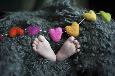 Baby's Feet Covered With Black Wool Textile thumbnail