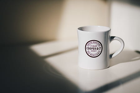 white ceramic mug on white surface thumbnail
