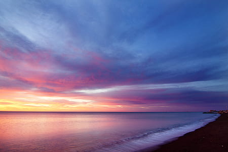 calm body of water under cloudy sky thumbnail