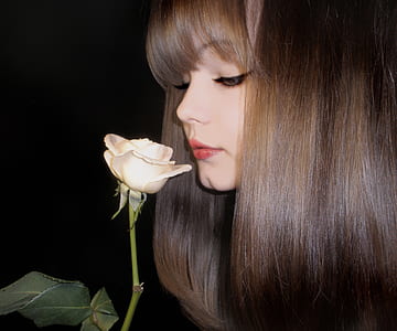 woman smelling white rose flower thumbnail