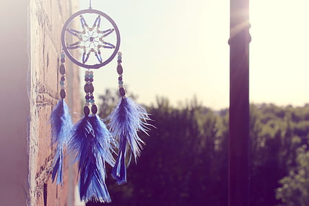 focus photography of brown and blue dreamcatcher thumbnail