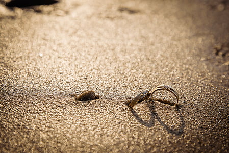 silver-colored couple rings on gray ground thumbnail