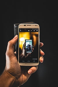 person holding white Android smartphone thumbnail