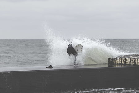 high wave crashing dock at daytime thumbnail