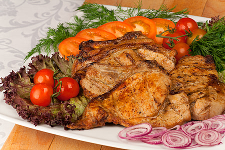 grilled meat slices with vegetables and spices on white plate thumbnail
