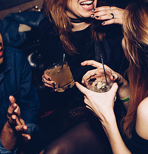 woman in black top holding drinking glass thumbnail