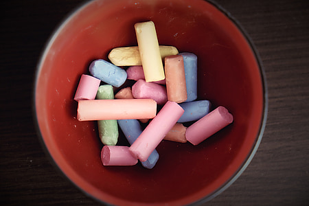 assorted-color chalks on red bowl thumbnail