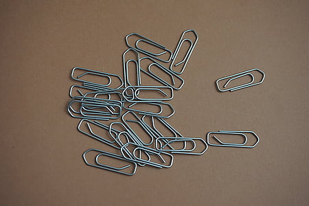 gray steel paper pin lot on brown surface thumbnail