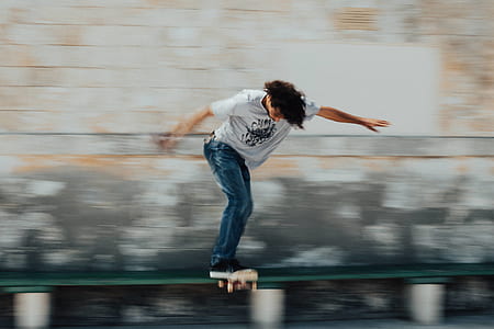 man in blue jeans riding skateboard thumbnail