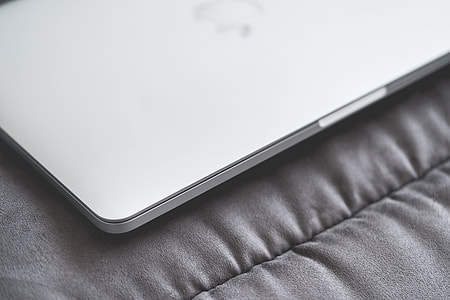 Closed Macbook Laptop on a Sofa #2 thumbnail