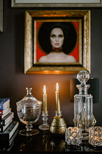 Decanter, candles, and a painting on the wall thumbnail