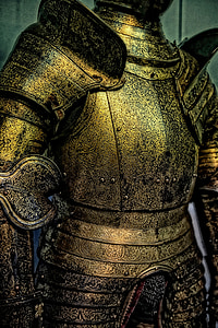 gold knight armor near gray painted wall thumbnail