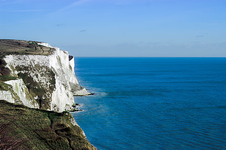 ocean and mountain under blue sky thumbnail