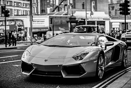 grayscale photography of super car on road thumbnail