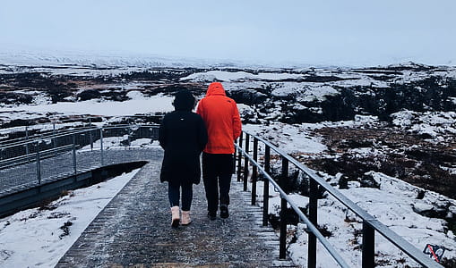 Two People Wearing Black And Red Winter Jackets thumbnail