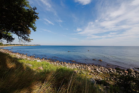body of water next to rock formations thumbnail