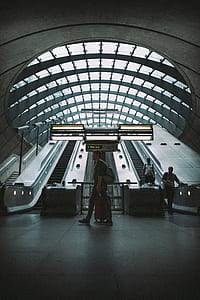 man holding luggage bag inside building thumbnail