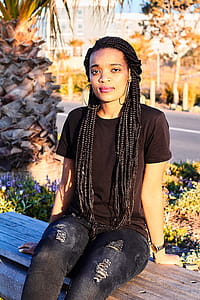 Woman Sitting on Bench Near Plants thumbnail