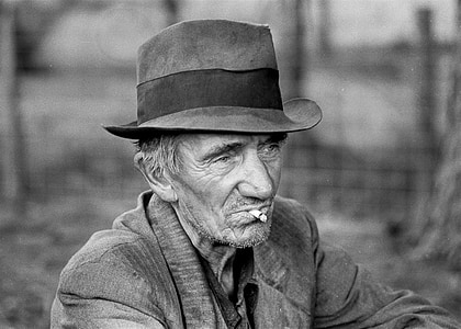 grayscale photo of man with hat and cigarette thumbnail