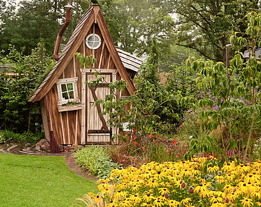 brown wooden cabin near green leafed tree thumbnail