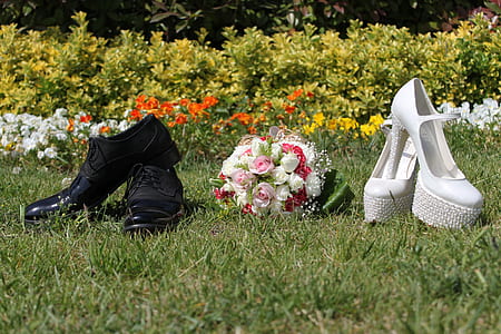 pair of women's white stilettos on grass field thumbnail