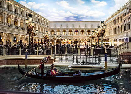 couple on gondola boat near concrete building thumbnail